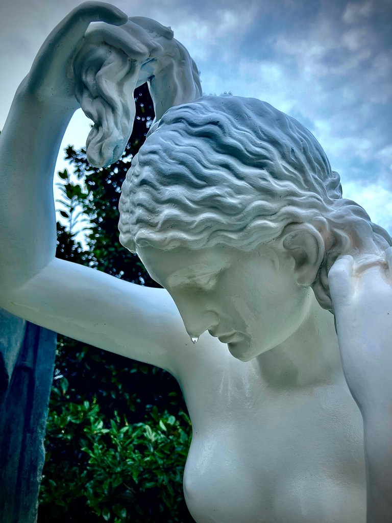 A photo of a statue that appears to be weeping. 