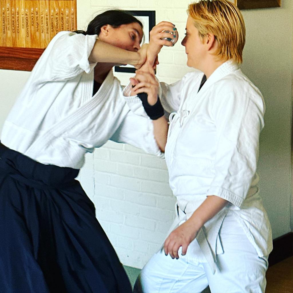 Laura and Jaime practicing aikido with metal tai chi balls.